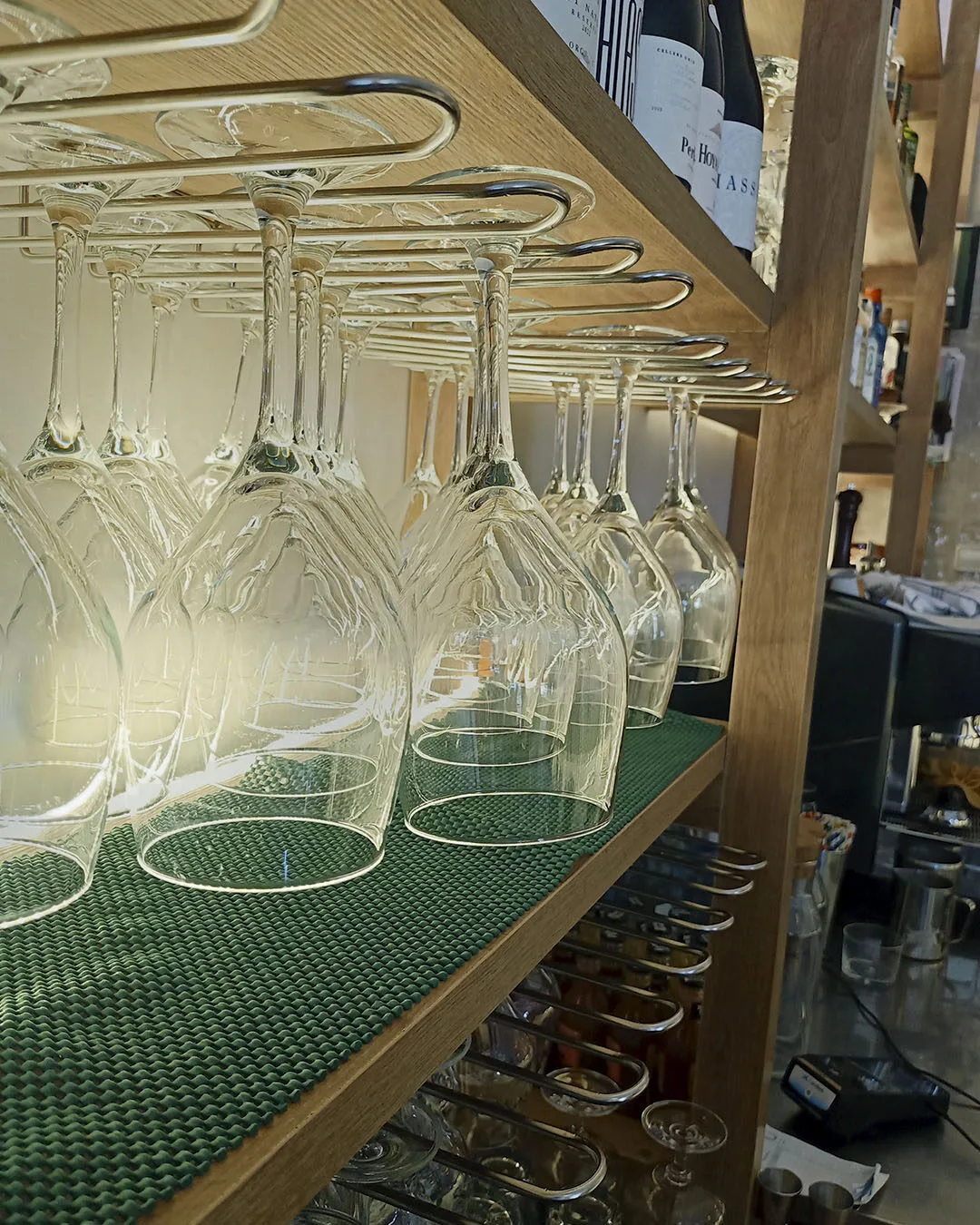 Copas de vino colgadas en la barra de Silvestre Becerril.